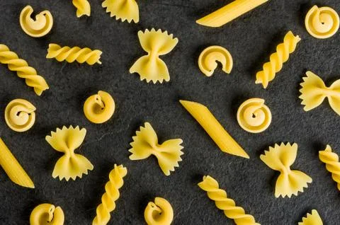 Different types of pasta on a slate background 库存照片