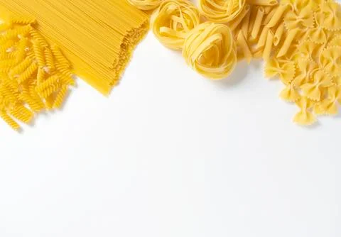 Different types of pasta on white background with space Stock Photos