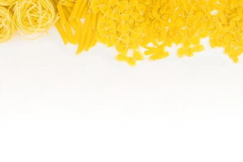 Different types of pasta on a white background. Raw macaroni. Stock Photos