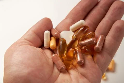 Different types of pills and tablets on pink background Stock Photos