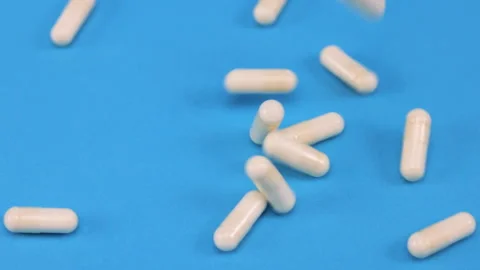 Different types of pills fall on the table Stock Footage 276510845
