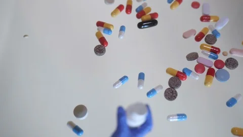 Different types pills falling back in bottle Stock Footage 120210048
