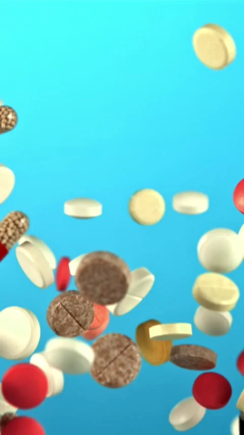 Different types of pills fly up and fall down. Filmed on a high-speed camera at Stock Footage 335292959