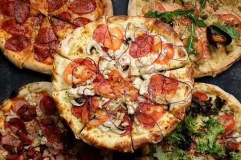 Different types of pizza with different toppings Stock Photos