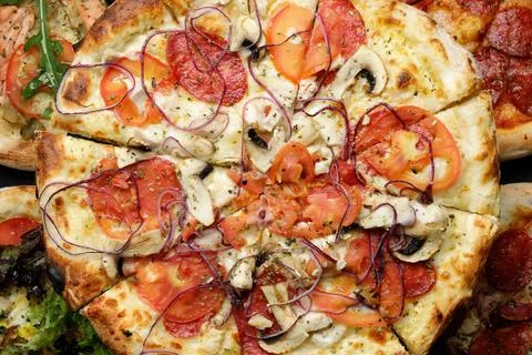 Different types of pizza with different toppings Stock Photos