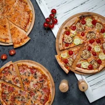 Different types of pizza on the table 1 Stock Photos