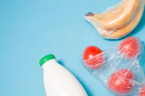 Different types of plastic packaging on a blue background, a package with tom Stock Photos