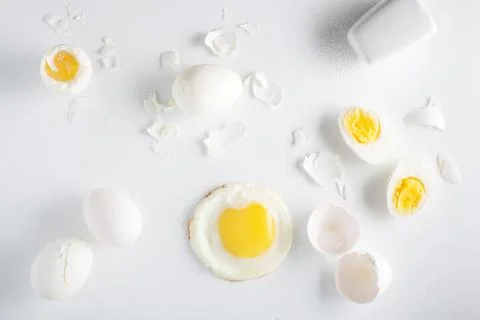 Different types of prepared eggs on white background. Overhead view Stock Photos