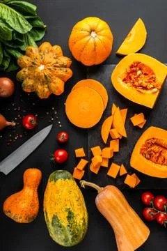 Different types of pumpkins and cherry tomato. Top view. Stock Photos