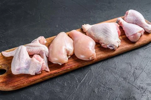 Different types of raw chicken meat, poultry. Black background. Top view Stock Photos