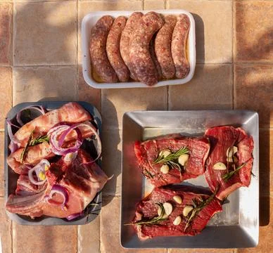 Different types of raw meat and beef. Fresh raw meats on an outdoor table rea Stock Photos