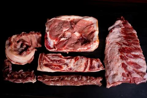 Different types of raw meat with fresh herbs. Stock Photos