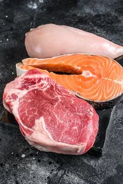 Different types of raw meat steaks Beef striploin, salmon and chicken breast Stock Photos