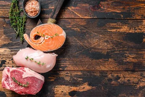 Different types of raw meat steaks Beef striploin, salmon and chicken breast Stock Photos
