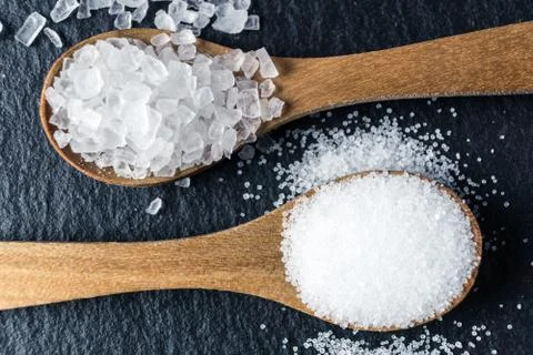 Different types of salt. Top view on two wooden spoons Stock Photos
