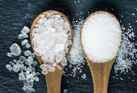 Different types of salt. Top view on two wooden spoons Stock Photos