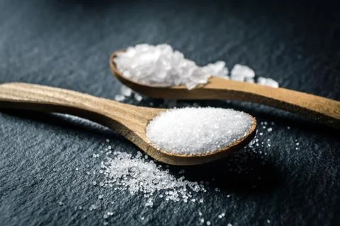 Different types of salt. Top view on two wooden spoons Stock Photos