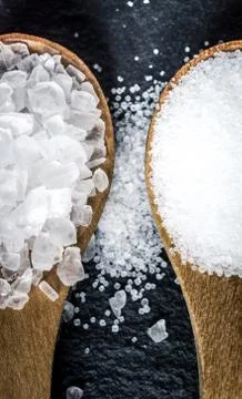 Different types of salt. Top view on two wooden spoons Stock Photos