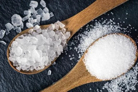 Different types of salt. Top view on two wooden spoons Stock Photos