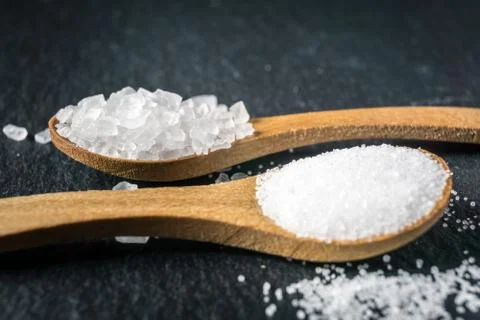 Different types of salt. Top view on two wooden spoons Stock Photos
