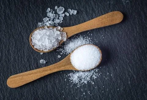 Different types of salt. Top view on two wooden spoons Stock Photos