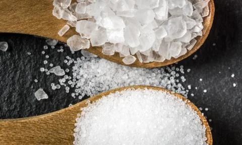 Different types of salt. Top view on two wooden spoons Stock Photos
