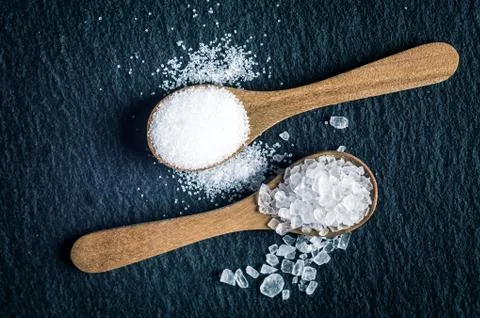 Different types of salt. Top view on two wooden spoons Stock Photos