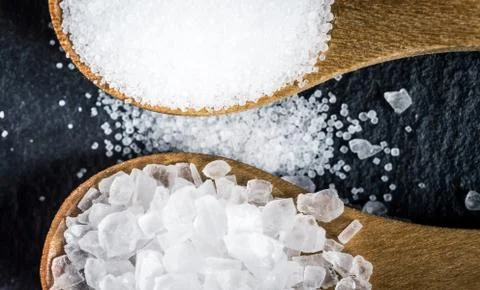 Different types of salt. Top view on two wooden spoons Stock Photos