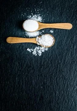 Different types of salt. Top view on two wooden spoons Stock Photos