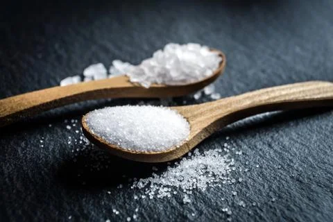 Different types of salt. Top view on two wooden spoons Stock Photos