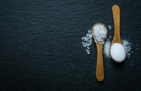 Different types of salt. Top view on two wooden spoons Stock Photos