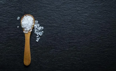 Different types of salt. Top view on wooden spoons Stock Photos