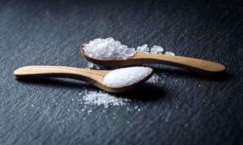 Different types of salt. Top view on two wooden spoons Stock Photos