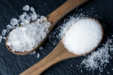 Different types of salt. Top view on two wooden spoons Stock Photos