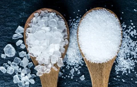 Different types of salt. Top view on two wooden spoons Stock Photos