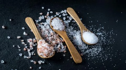 Different types of salt. Top view on three wooden spoons Stock Photos