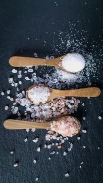 Different types of salt. Top view on three wooden spoons Stock Photos