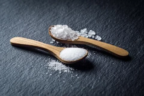 Different types of salt. Top view on two wooden spoons Stock Photos
