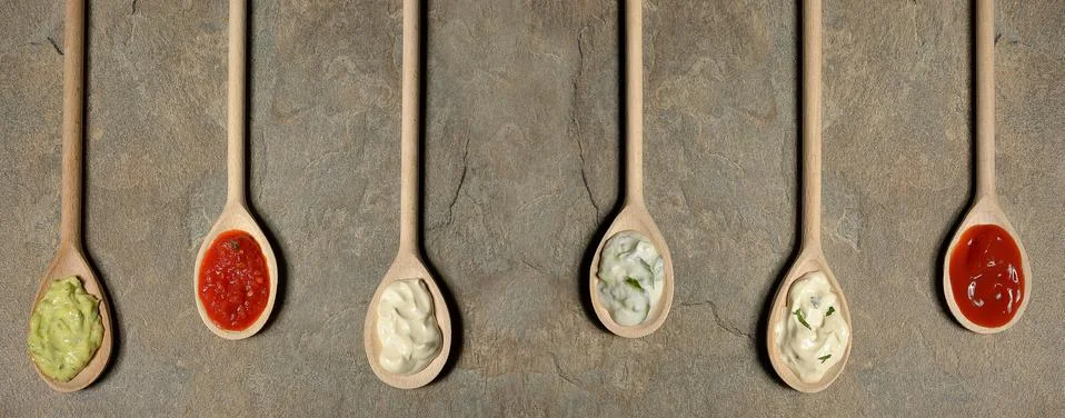 Different types of sauces in spoons Free Stock Photos