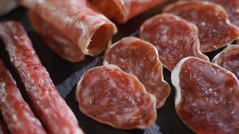 Different types of sausages and meat products on a black background Video stock 116877992