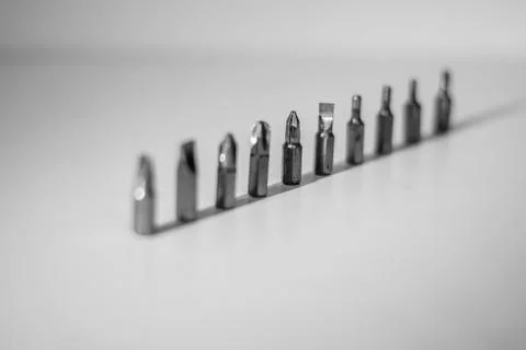 Different types of screw bits of screwdriver isolated on white background. Stock Photos