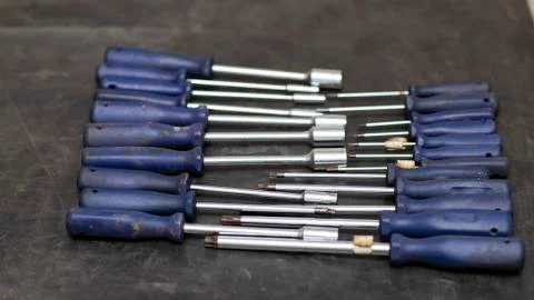 Different types of screwdrivers on the workbench. Stock Photos