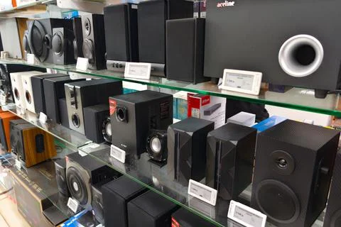 Different types of speakers displayed on a shelf in an electronics store during Stock Photos