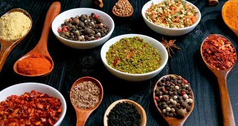 Different types of spices on a dark background Stock Photos