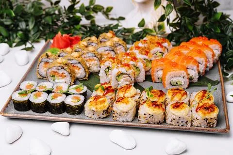 Different types of sushi rolls on big plate Stock Photos