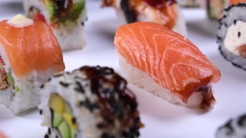 Different types of sushi, rolls with tuna and salmon, rice caviar and fish on a Stock Footage 228714123