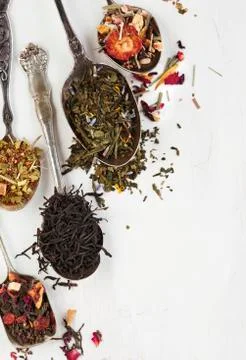 Different types of tea leaves in spoons Stock Photos
