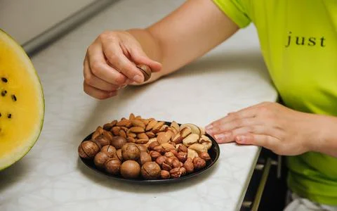 Different types  useful nuts laid out on a plate Stock Photos