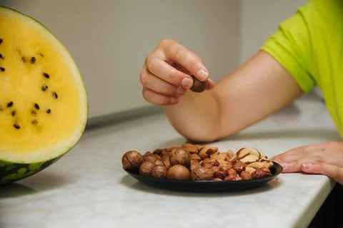 Different types  useful nuts laid out on a plate Stock Photos