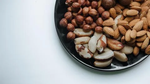 Different types  useful nuts laid out on a plate Stock Photos